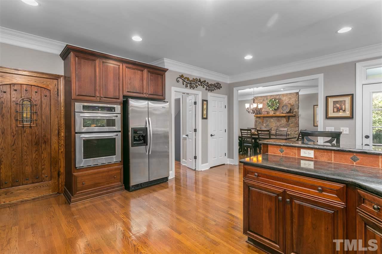 8005 Kukui Court Raleigh, NC 27613 - Photo 7 of 30 a kitchen with stainless steel appliances granite countertop a refrigerator and a stove top oven