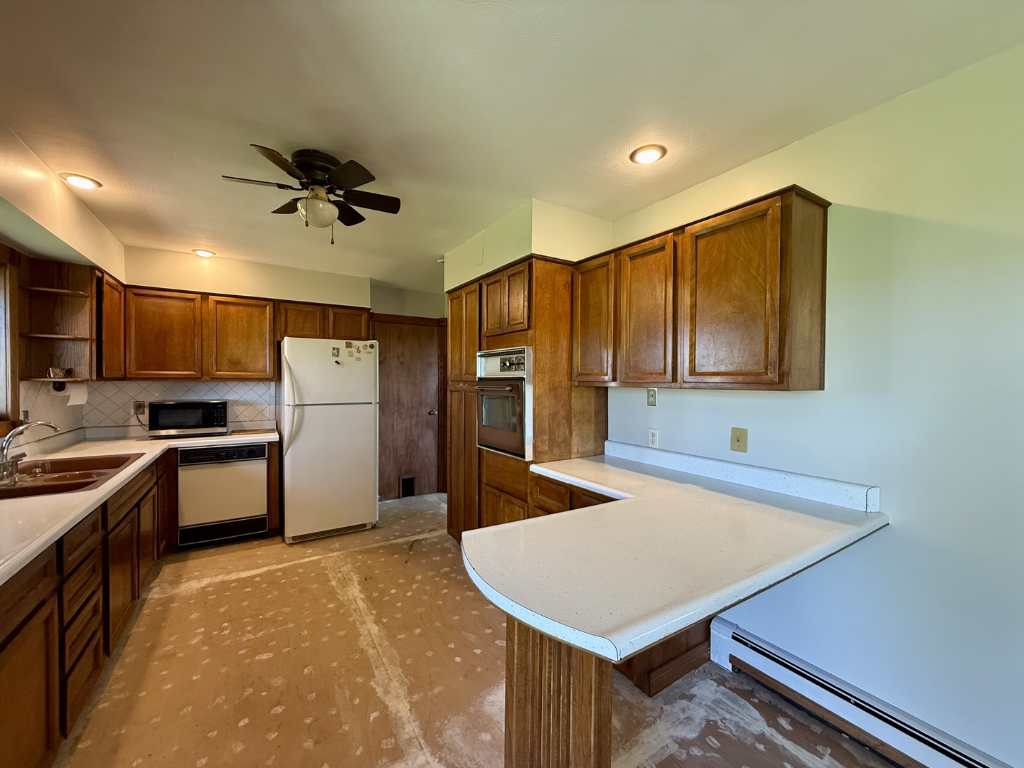 2052 County Road 3000 North Rantoul, IL 61866 - Photo 8 of 21 a kitchen with refrigerator cabinets and wooden floor