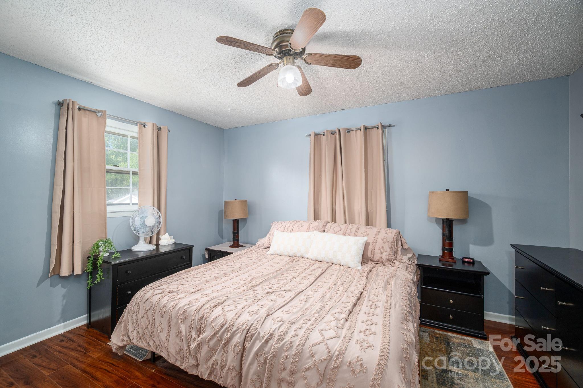 109 White Rock Road Grover, NC 28073 - Photo 12 of 37 a bedroom with a bed and a chandelier