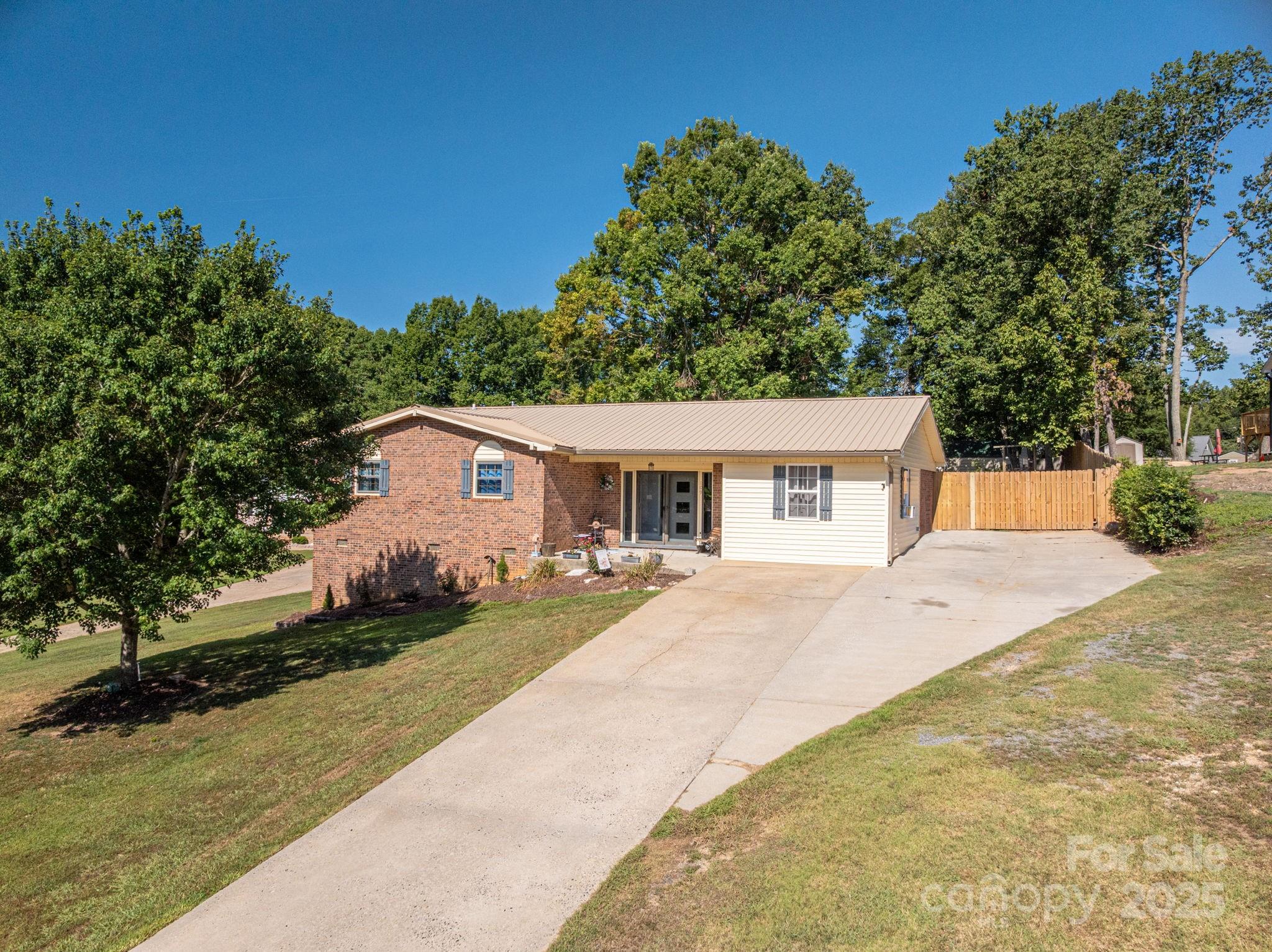 109 White Rock Road Grover, NC 28073 - Photo 25 of 37 a front view of a house with a garden and trees