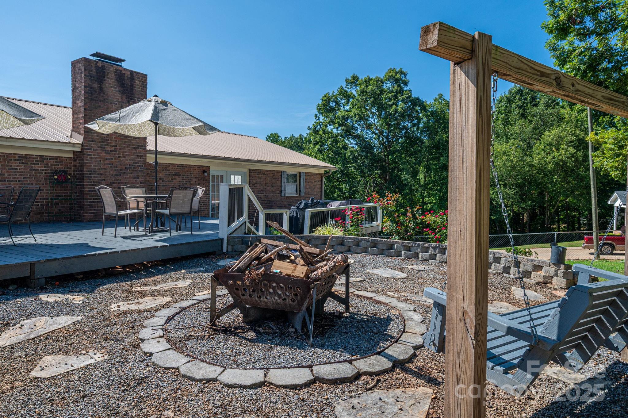 109 White Rock Road Grover, NC 28073 - Photo 32 of 37 a view of a patio with table and chairs potted plants with wooden fence