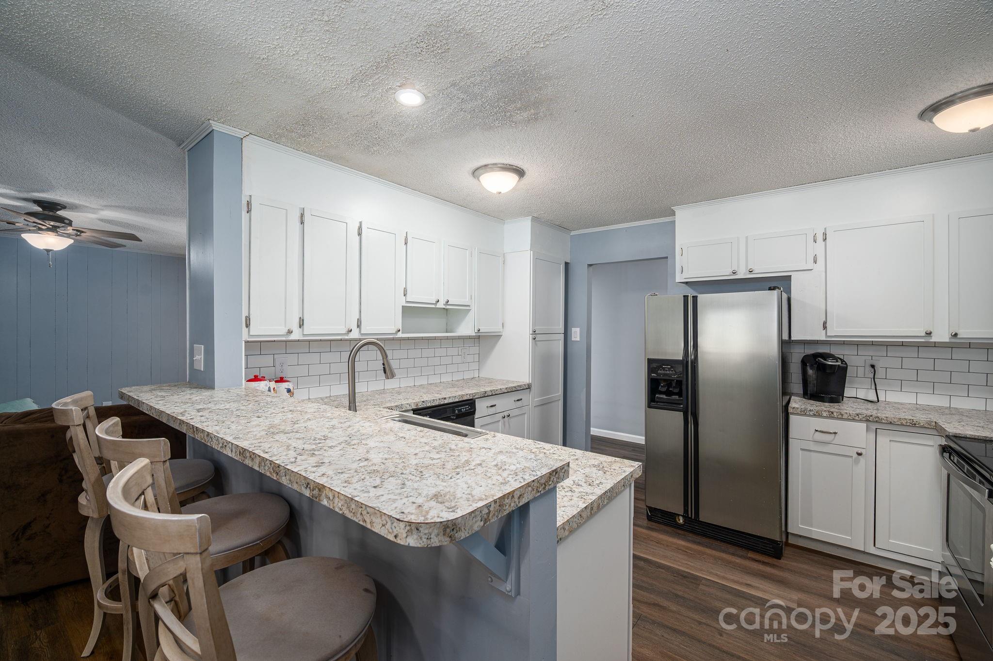 109 White Rock Road Grover, NC 28073 - Photo 8 of 37 a kitchen with stainless steel appliances granite countertop a table chairs sink refrigerator and cabinets