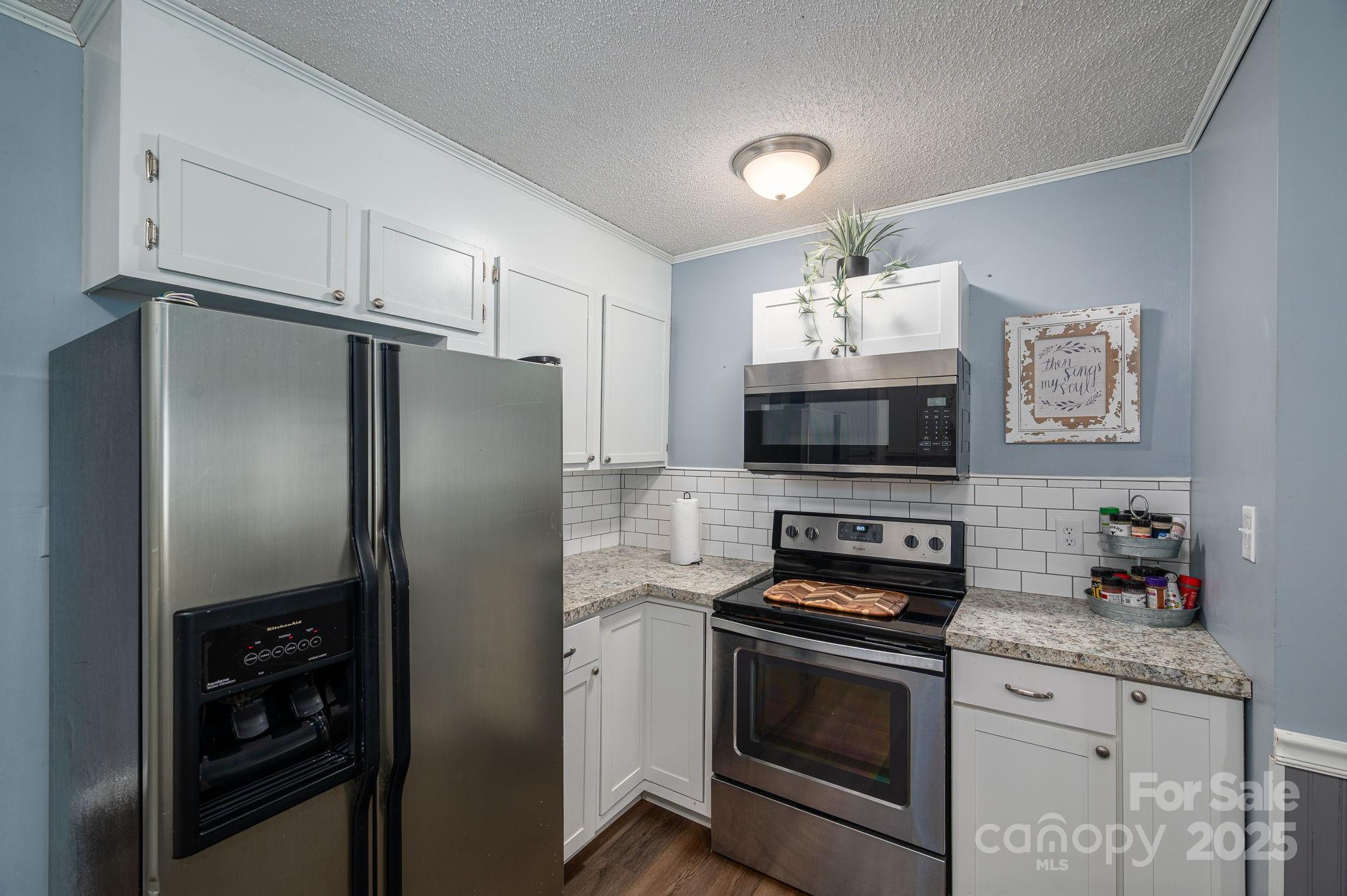 109 White Rock Road Grover, NC 28073 - Photo 10 of 37 a kitchen with a refrigerator stove and microwave