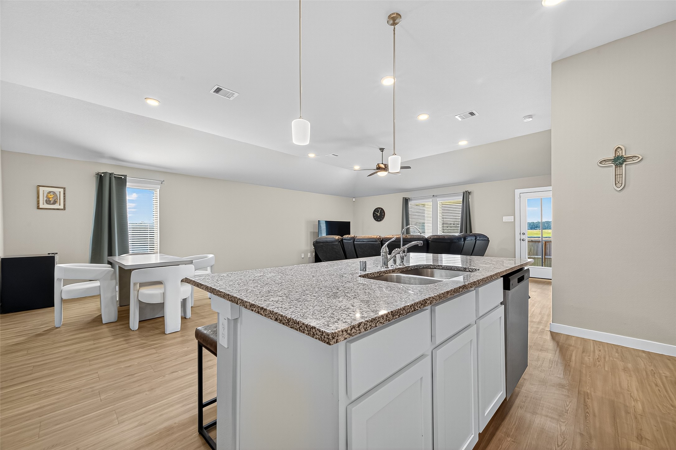 a kitchen with a stove a counter top space and wooden floor
