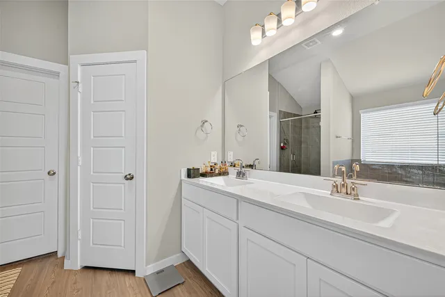a bathroom with a double vanity sink and a mirror