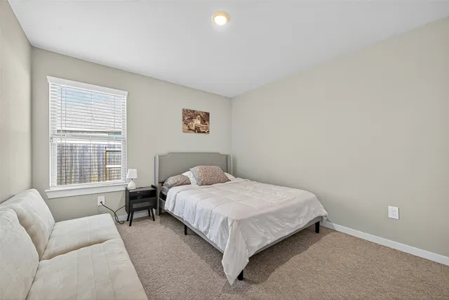 a bedroom with a bed and a couch