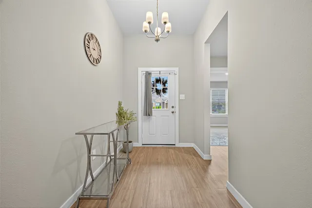 a view of hallway with wooden floor