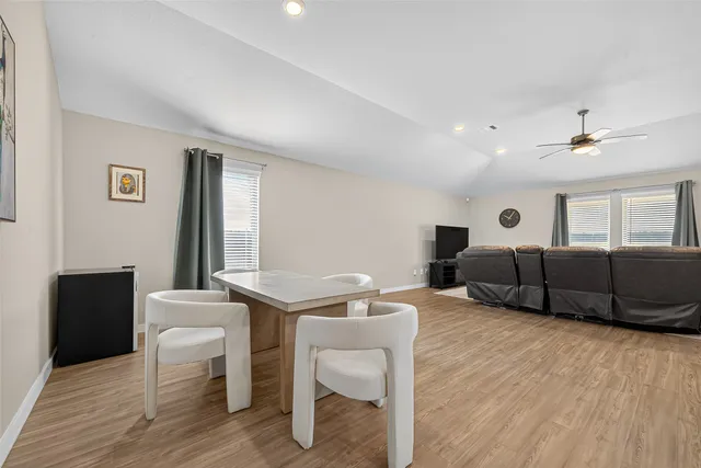 a dining room with furniture and wooden floor