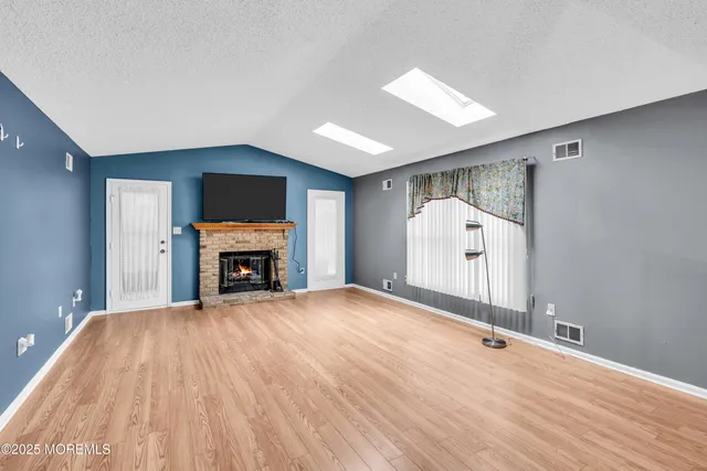 a view of empty room with fireplace and fan
