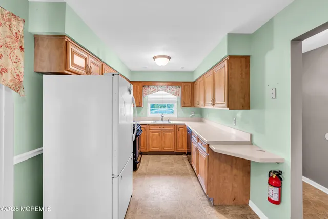 a kitchen with a refrigerator and a sink