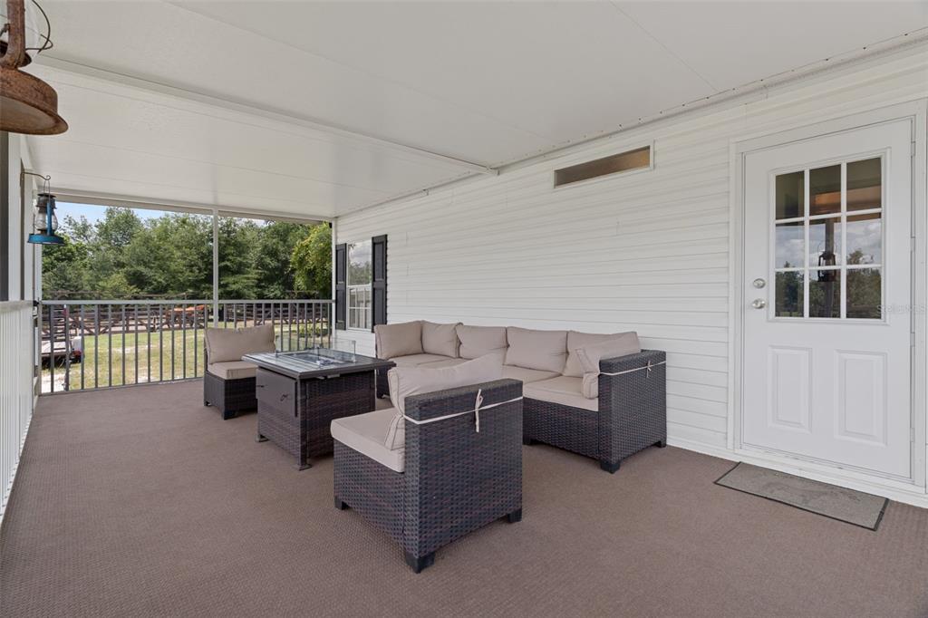 26255 Lambeth Road Brooksville, FL 34601 - Photo 51 of 76 a living room with furniture and a floor to ceiling window