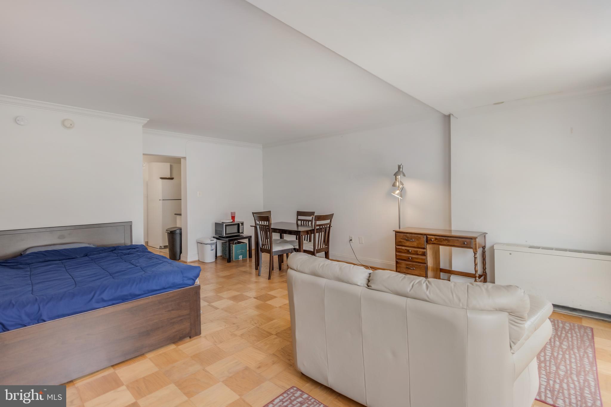 922 24th Street Northwest, Unit 415 Washington, DC 20037 - Photo 13 of 25 a living room with furniture and a dining table
