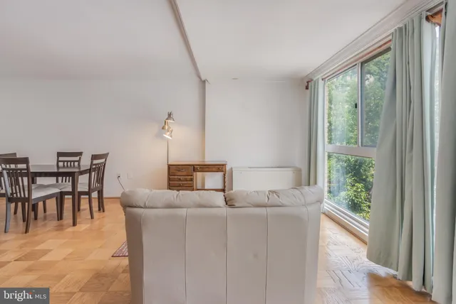 a dining room with furniture and a window