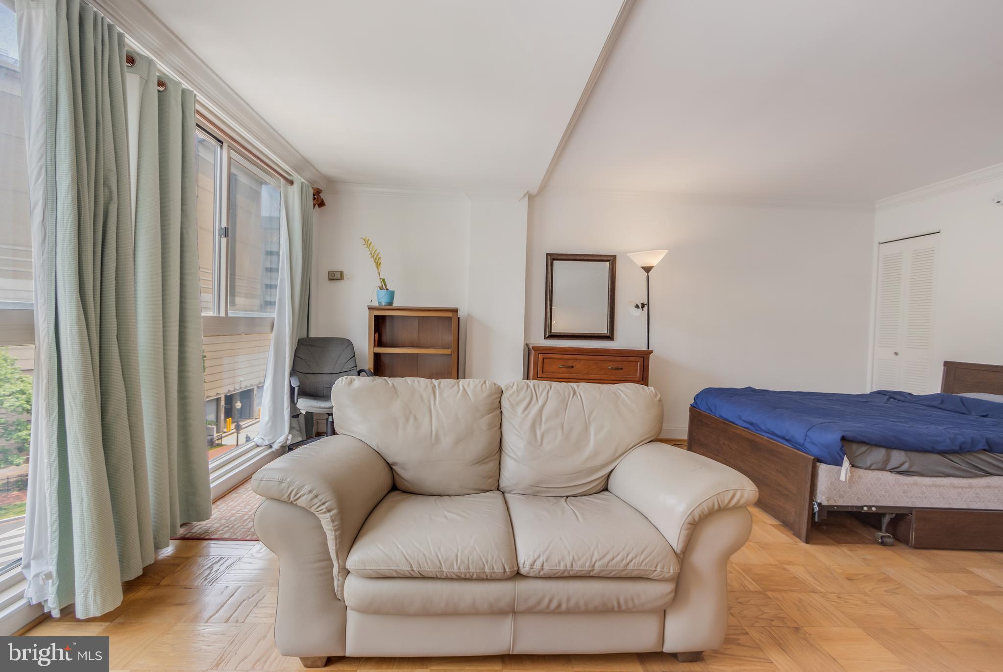 922 24th Street Northwest, Unit 415 Washington, DC 20037 - Photo 15 of 25 a living room with furniture and a window