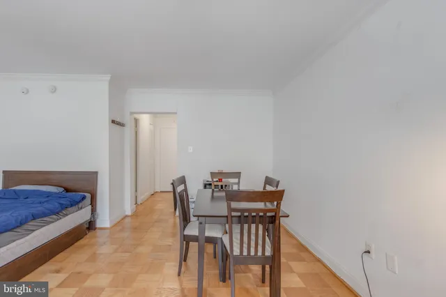 a view of a room with a table and chairs
