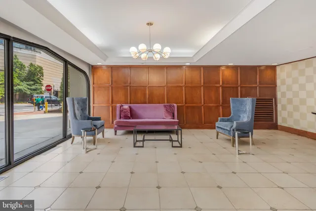 a living room with furniture a rug and a chandelier