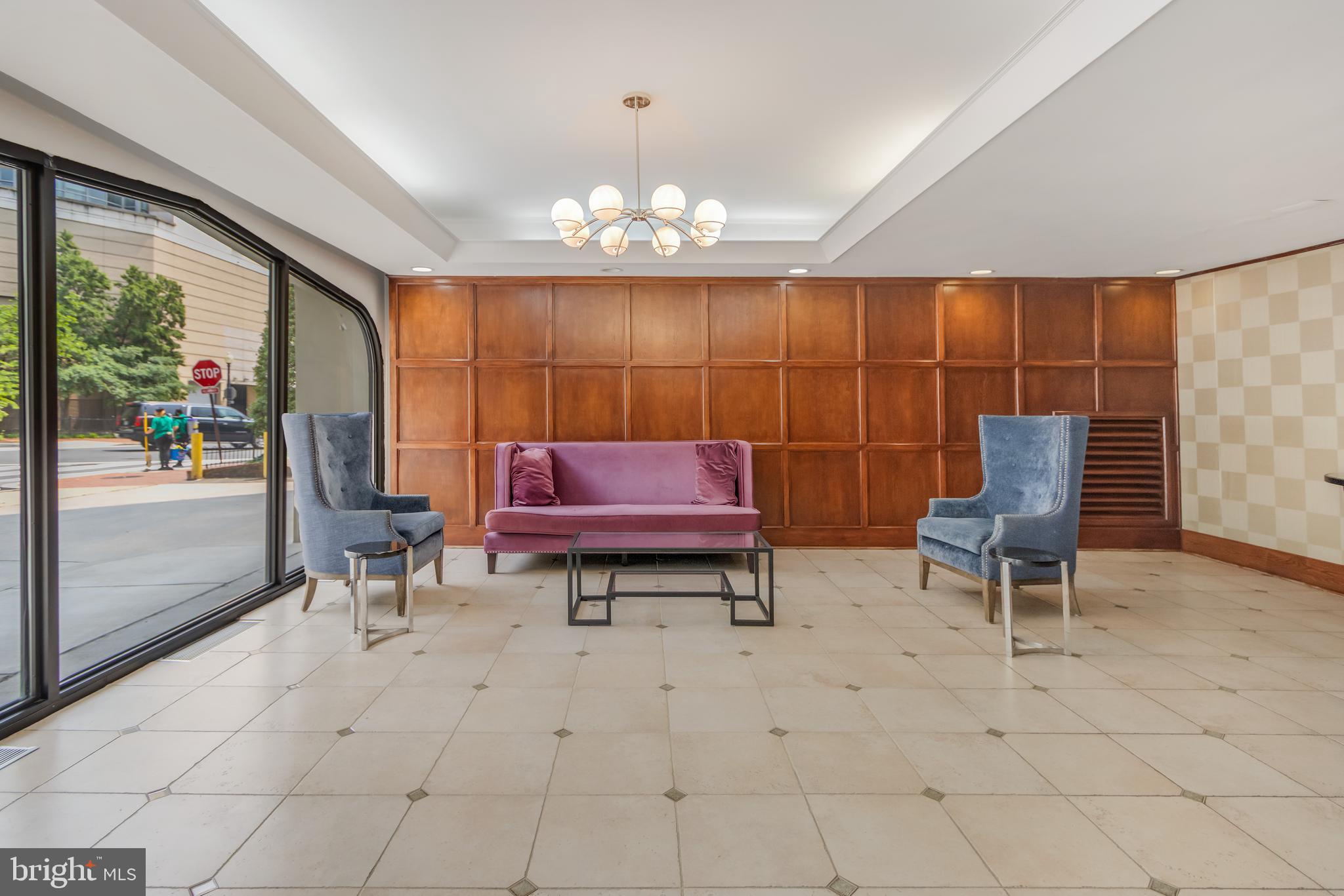 922 24th Street Northwest, Unit 415 Washington, DC 20037 - Photo 22 of 25 a living room with furniture a rug and a chandelier