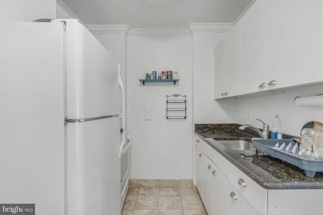a kitchen with stainless steel appliances granite countertop a refrigerator and a stove