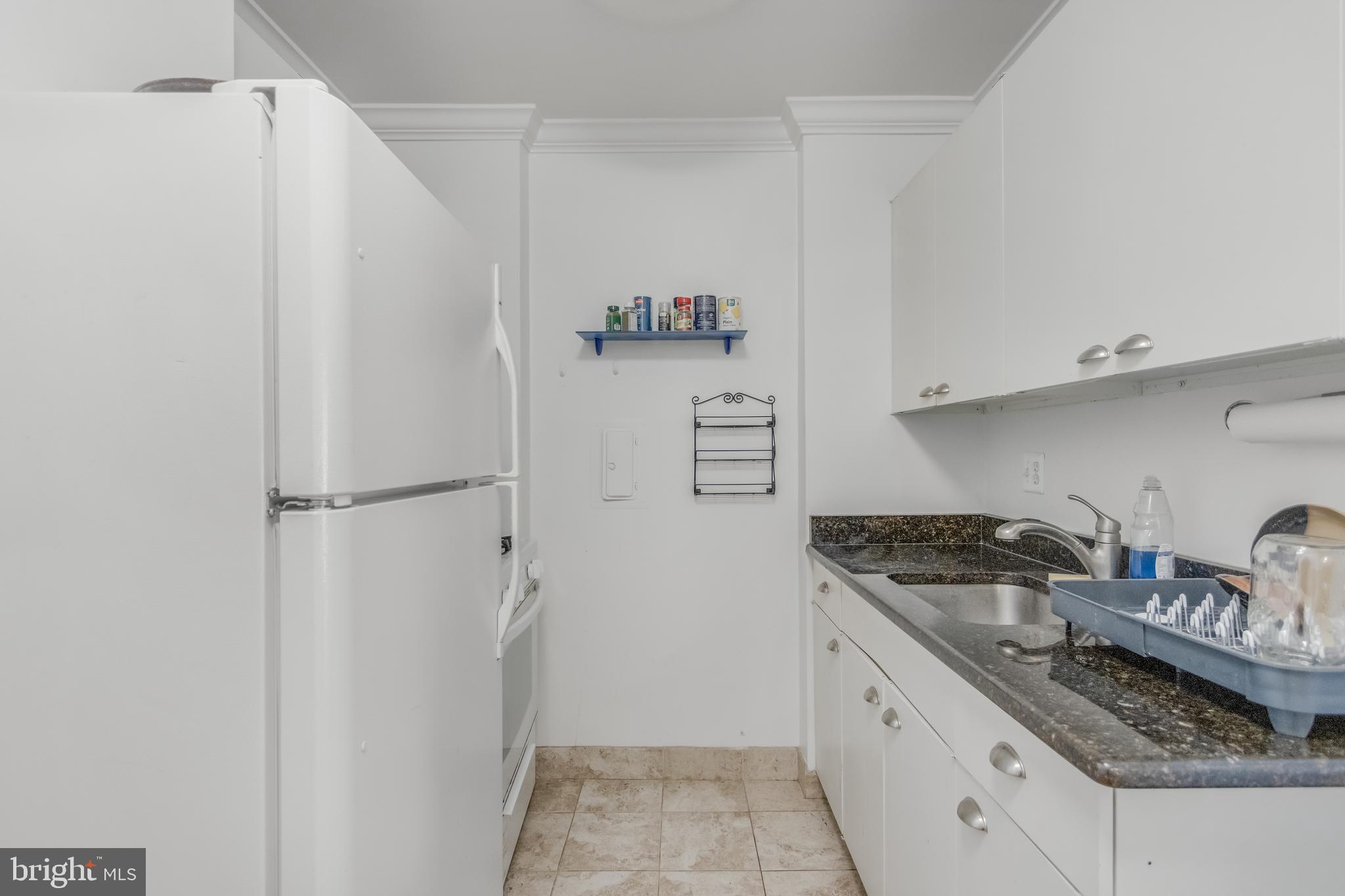 922 24th Street Northwest, Unit 415 Washington, DC 20037 - Photo 3 of 25 a kitchen with stainless steel appliances granite countertop a refrigerator and a stove