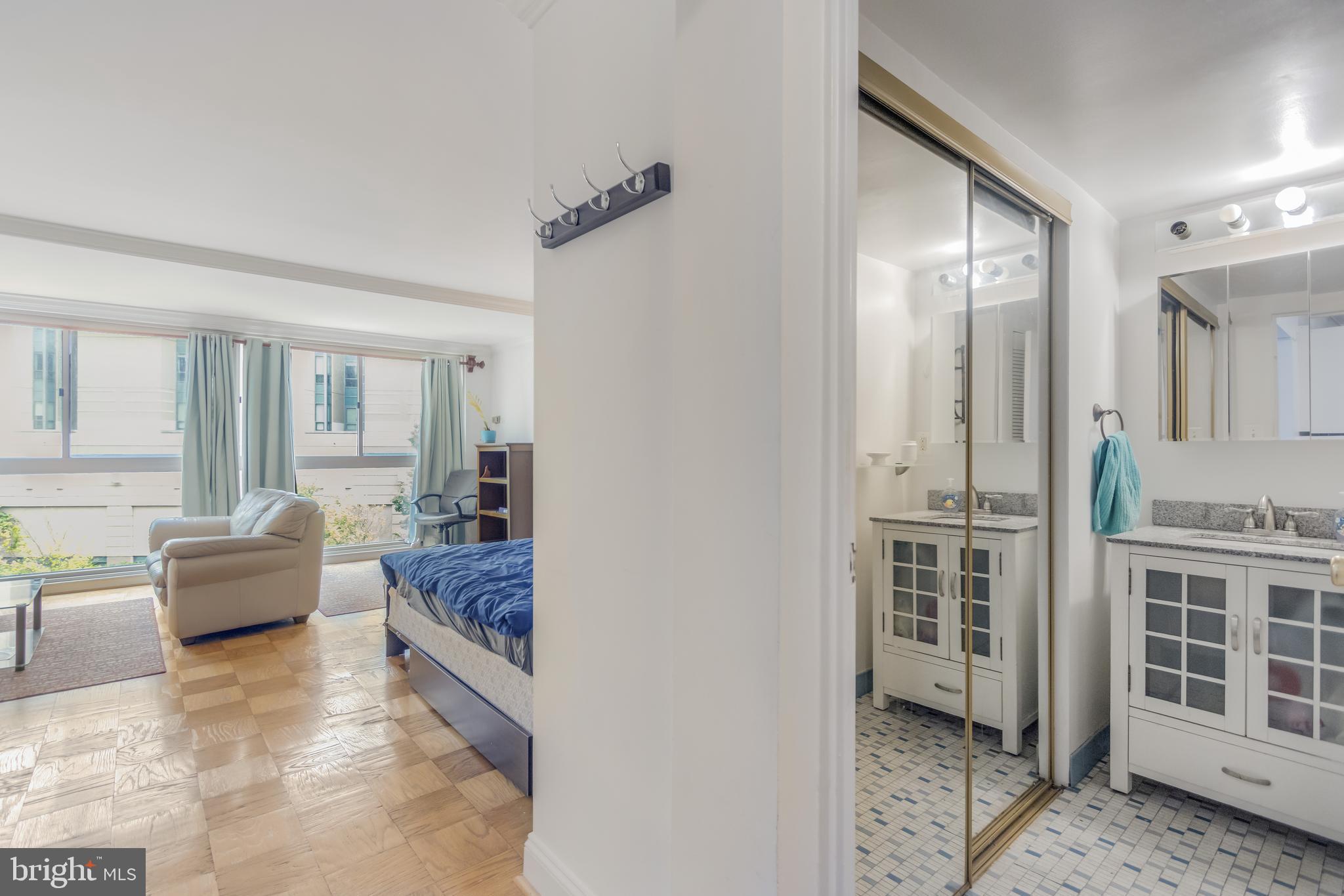 922 24th Street Northwest, Unit 415 Washington, DC 20037 - Photo 9 of 25 a living room with furniture and a window