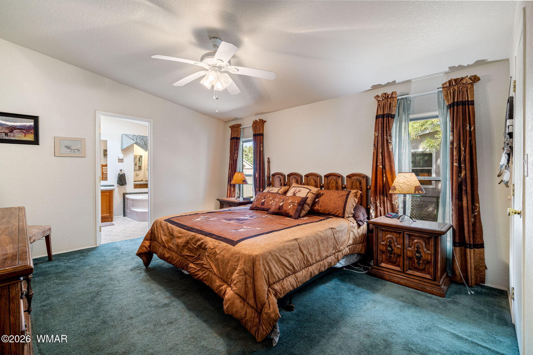 2908 Pine Rim Road Overgaard, AZ 85933 - Photo 14 of 34 a spacious bedroom with a bed and a chandelier
