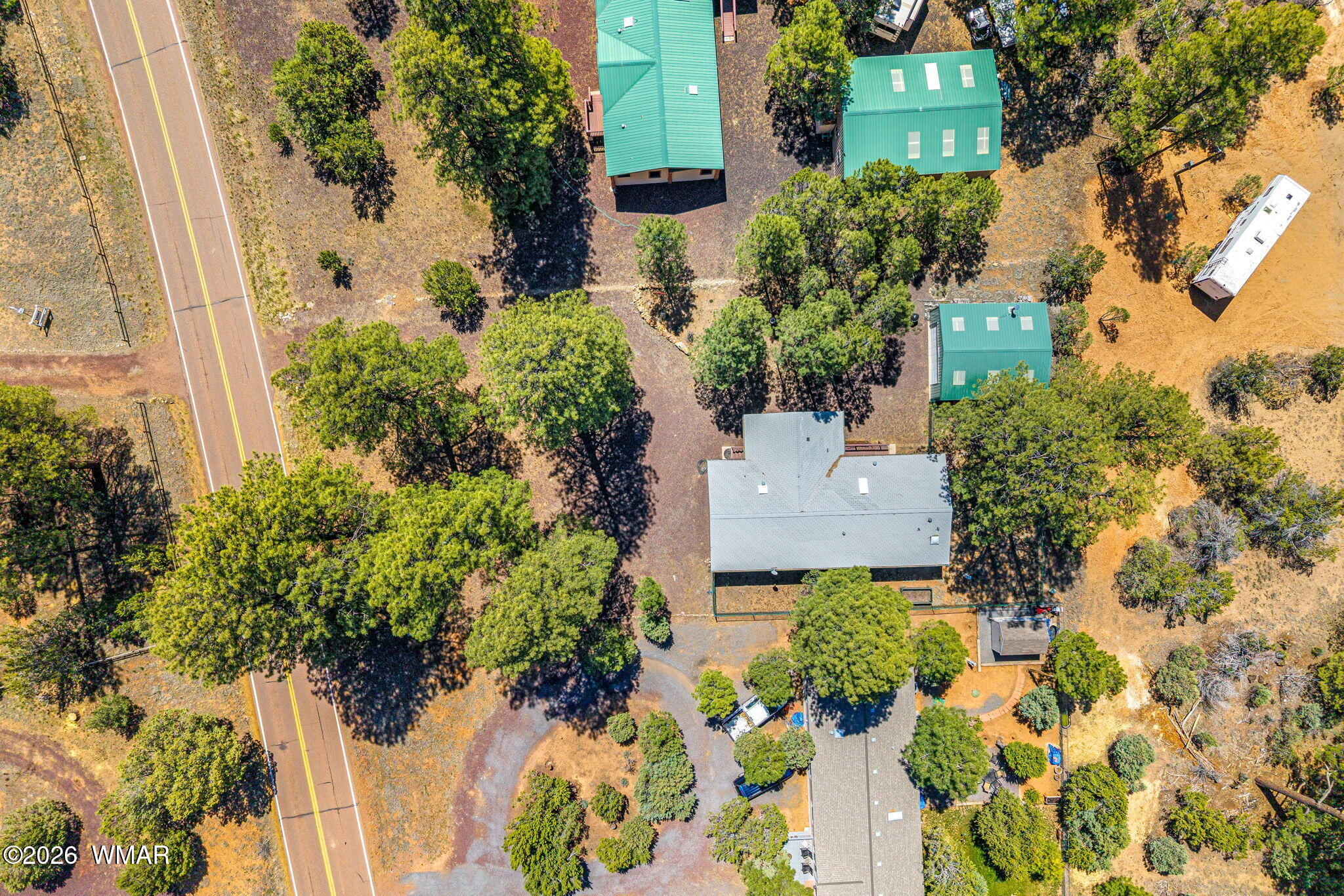 2908 Pine Rim Road Overgaard, AZ 85933 - Photo 31 of 34 an aerial view of a house with a yard and garden