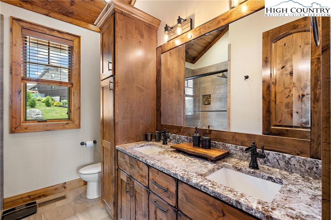 60 Camp Eagle Loop Banner Elk, NC 28604 - Photo 20 of 36 a bathroom with a granite countertop double vanity sink a mirror and a shower