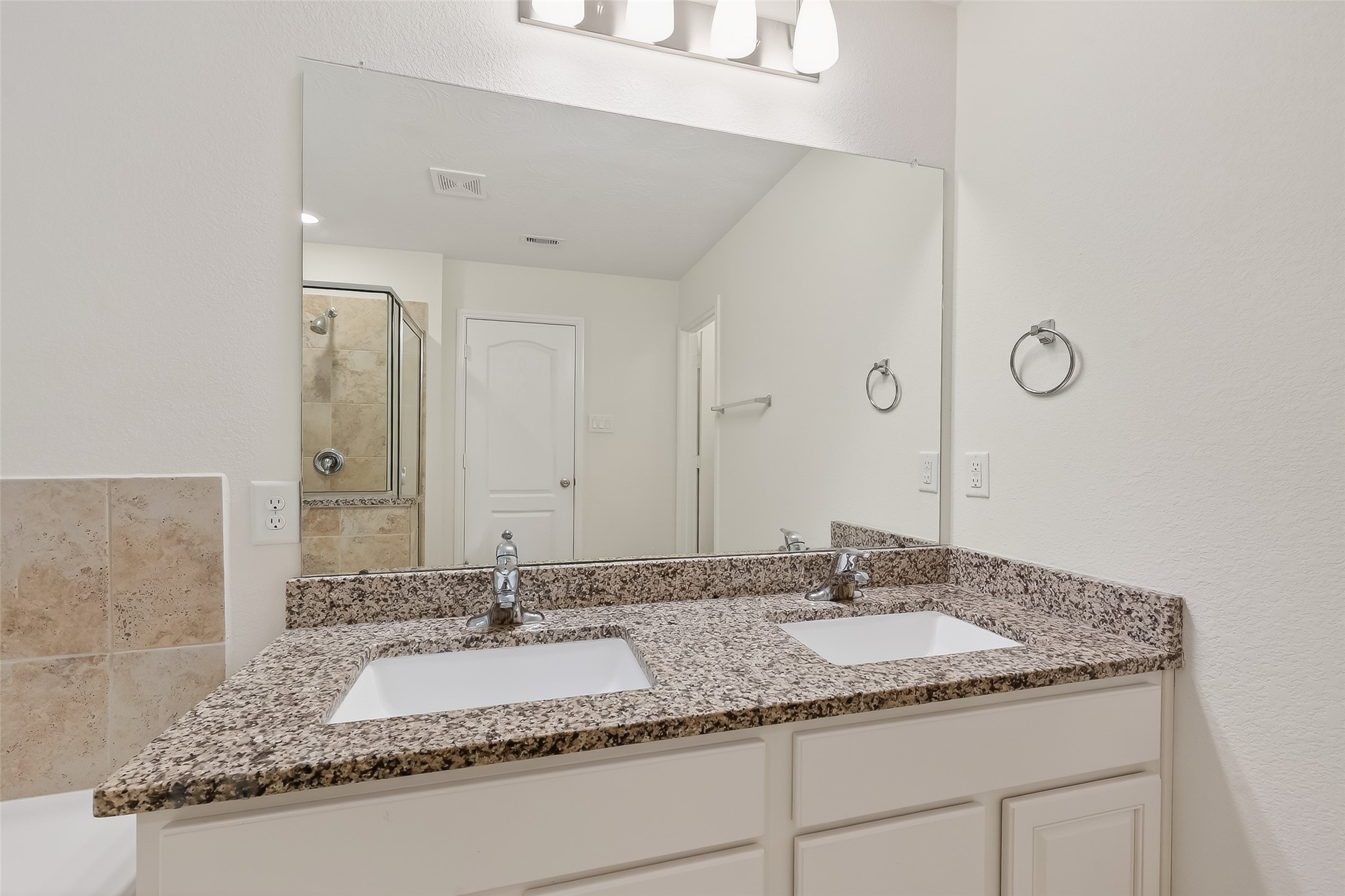 2107 Parnevik Place Conroe, TX 77304 - Photo 27 of 44 With a granite countertop and double sinks