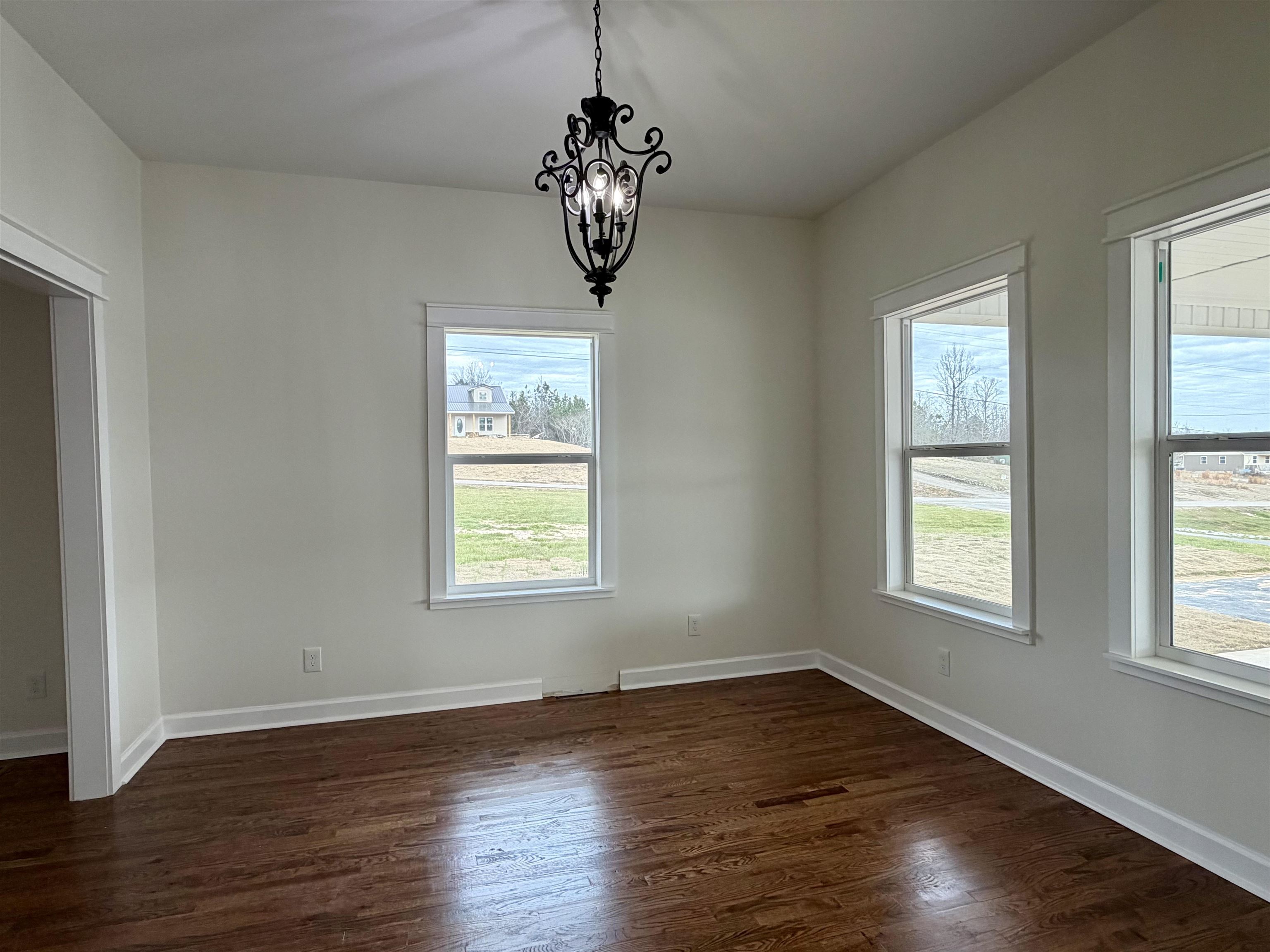 172 New Bethel Road Selmer, TN 38375 - Photo 16 of 30 a view of an empty room with wooden floor and a window