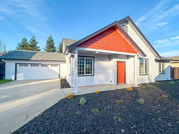 a view of a house with a yard and garage