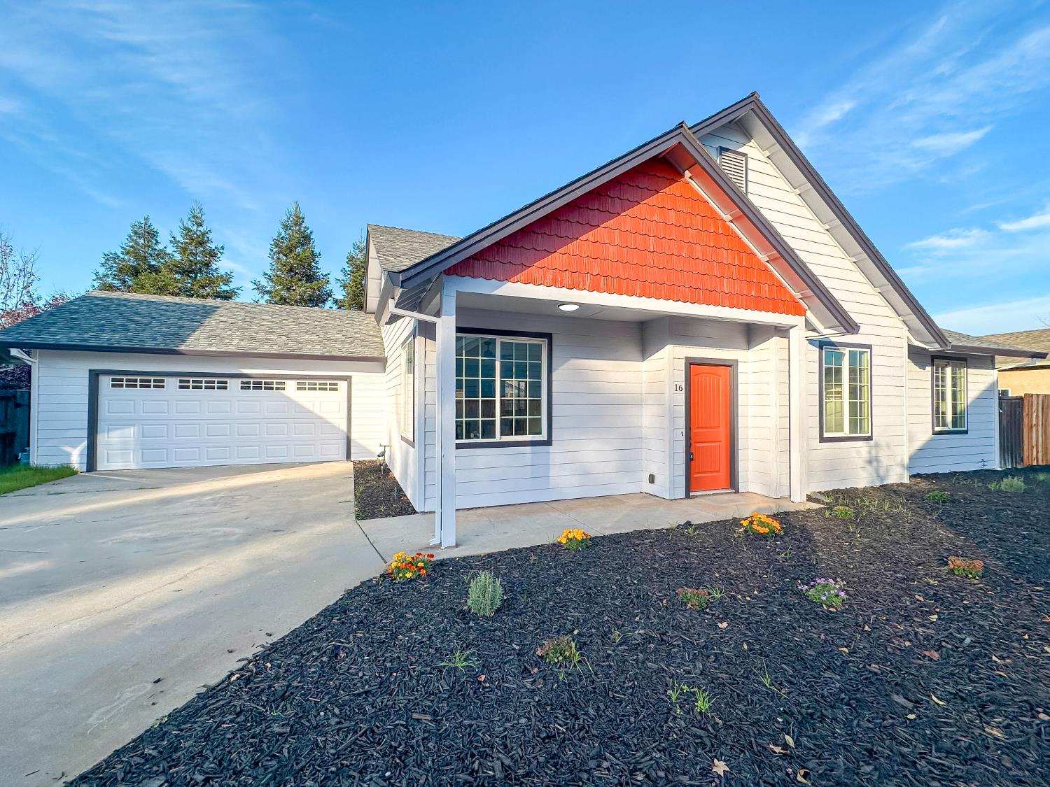 a view of a house with a yard and garage