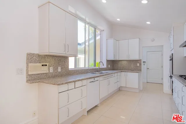 a view of a granite counter top a sink and a window