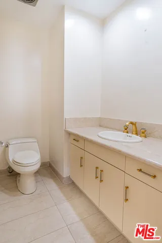an empty room with wooden floor and cabinet