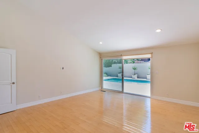 a bathroom with a granite countertop double vanity sink a mirror and a bathtub