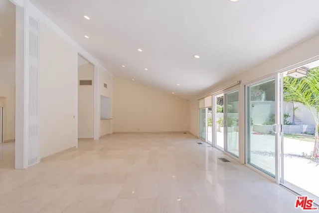 a view of an empty room with glass door