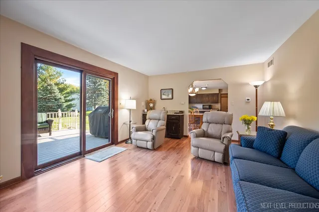 a view of a livingroom with furniture hardwood floor and a window