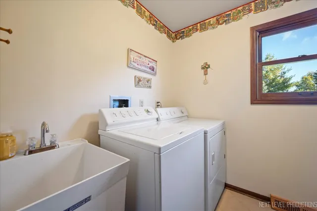 a spacious bedroom with a bed chairs and window