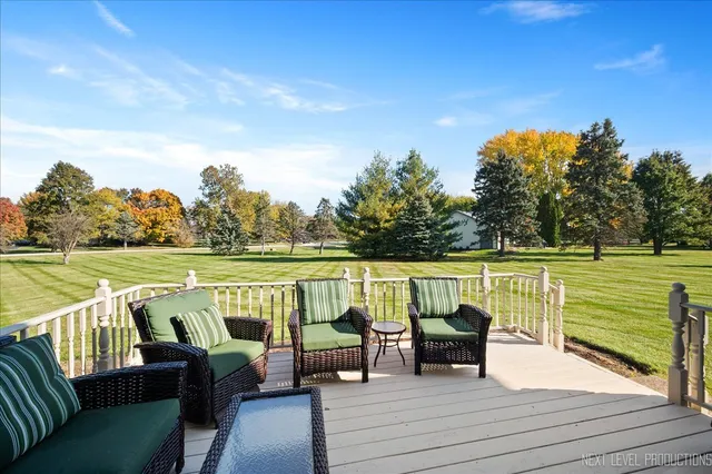 a front view of house with yard and trees in the background