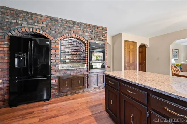 a dining room with furniture a chandelier and wooden floor