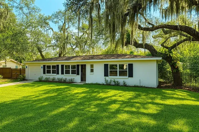 a view of a house with a yard