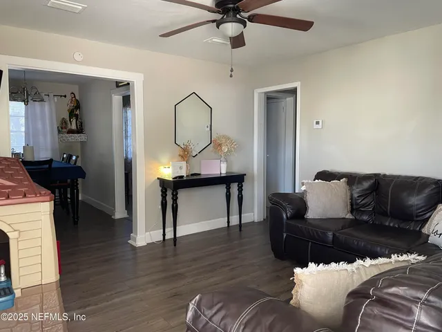 a view of a dining room with furniture and wooden floor