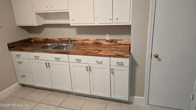 a bathroom with a sink a toilet a shower curtain and a mirror