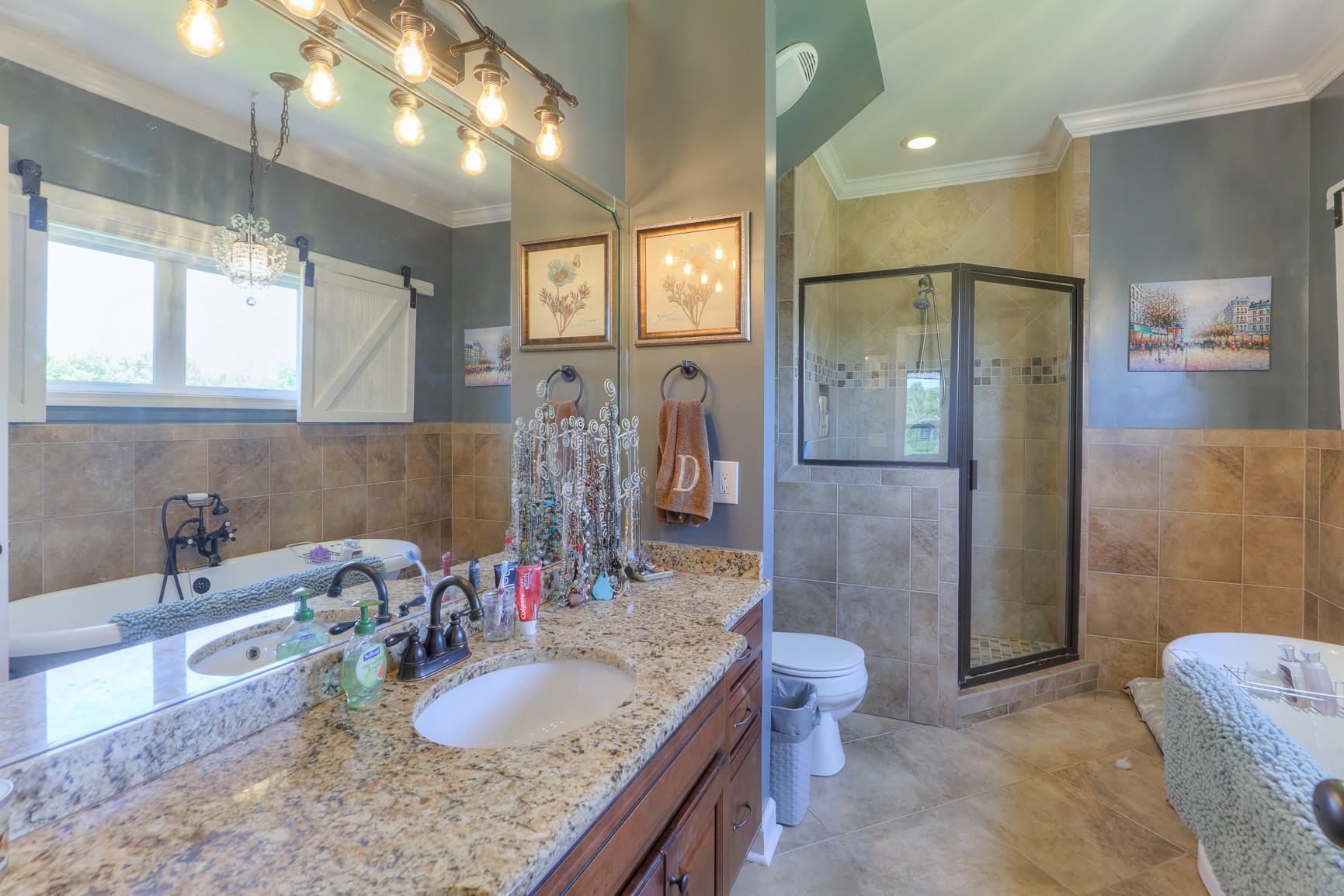 405 Burford Road Lebanon, TN 37087 - Photo 26 of 44 a bathroom with a granite countertop sink a toilet a mirror and shower