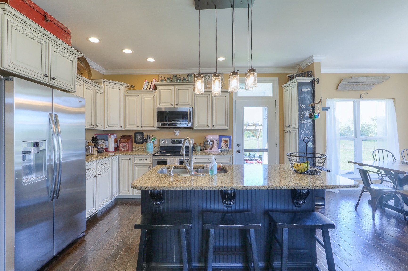 405 Burford Road Lebanon, TN 37087 - Photo 8 of 44 a kitchen with refrigerator cabinets dining table and chairs