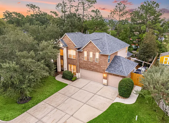 a aerial view of a house with yard and green space