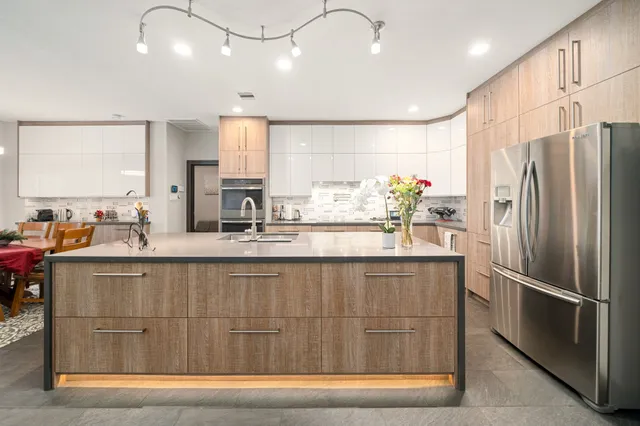 a kitchen with stainless steel appliances granite countertop a refrigerator and a sink