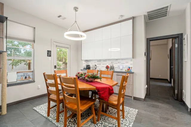 a view of a dining room and livingroom with furniture window and wooden floor