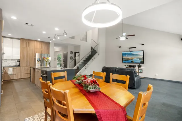 a living room with dining table and chairs