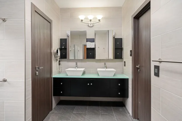 a bathroom with a double vanity sink and a mirror