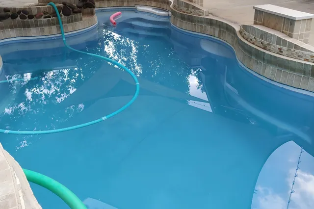 a view of a swimming pool with lounge chair